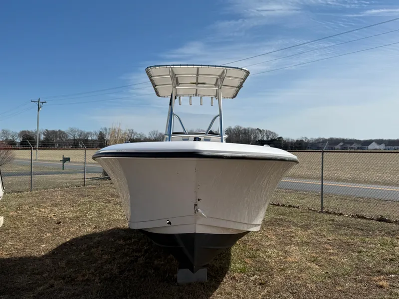 Slide: The Image of 2023 Aquasport 22CC boat on grass, clear sky background. - 2