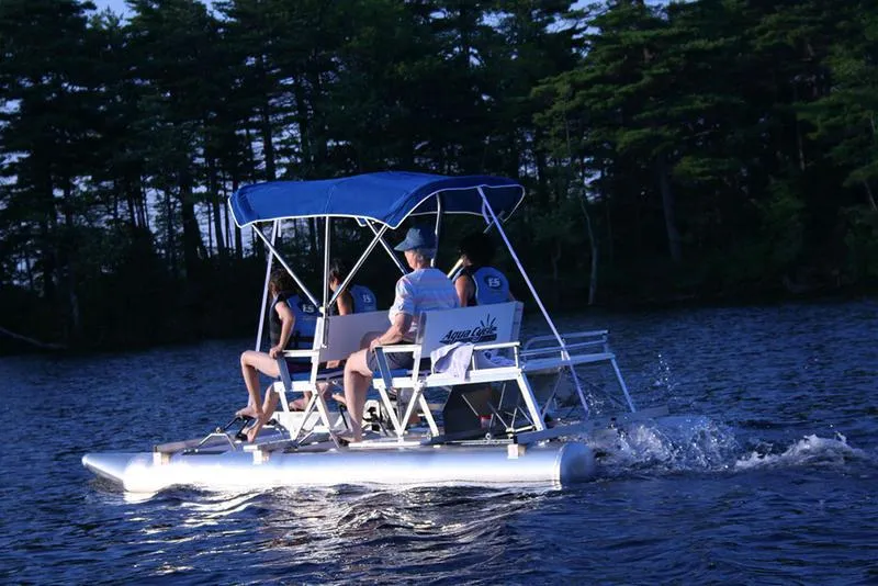 Slide: The Image of 2024 Aqua Cycle AC4x4W pedal boat on a serene lake at dusk. - 3