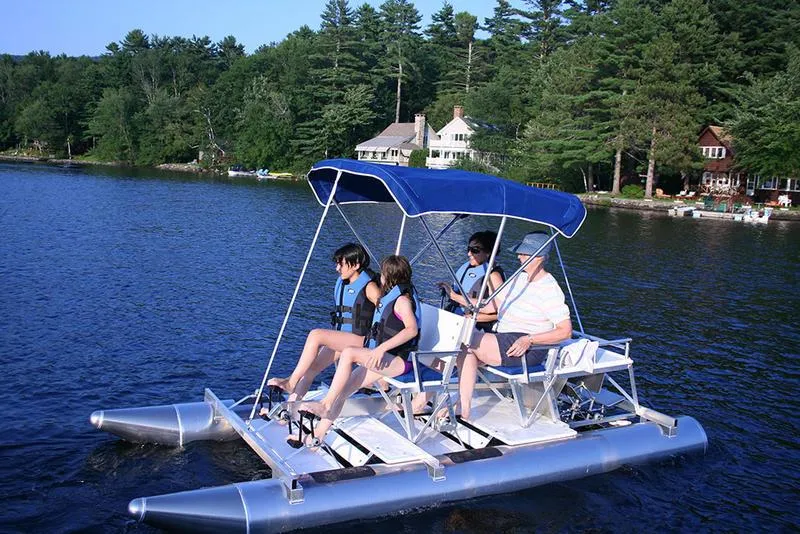 Slide: The Image of 2024 Aqua Cycle AC4x4W pedal boat with canopy on a serene lake. - 4