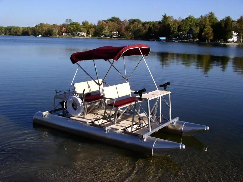 Slide: The Image of 2024 Aqua Cycle AC4x4W pedal boat on a serene lake with canopy. - 5