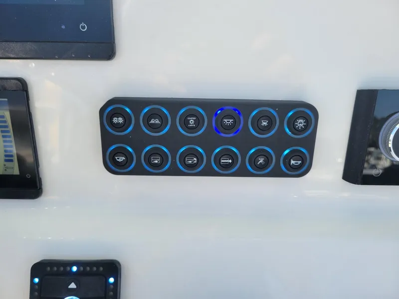 Slide: The Image of Control panel of 2025 Key West 239 FSR boat with illuminated buttons. - 14