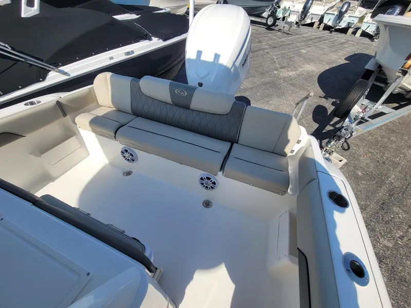 Slide: The Image of 2025 Key West 239 FSR boat interior with cushioned seating and speakers. - 17