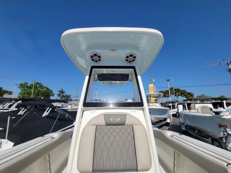 Slide: The Image of 2025 Key West 239 FSR boat interior with speakers and seating, under clear blue sky. - 19