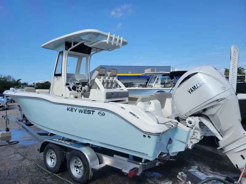 Slide: The Image of 2025 Key West 239 FSR boat on trailer with Yamaha engine, parked outdoors. - 2
