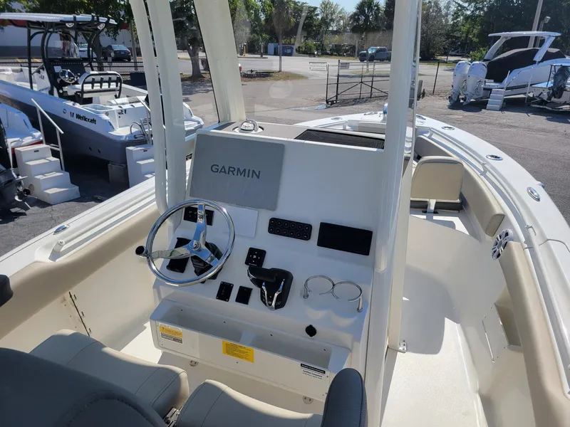 Slide: The Image of 2025 Key West 239 FSR boat interior with Garmin navigation system and steering wheel. - 8