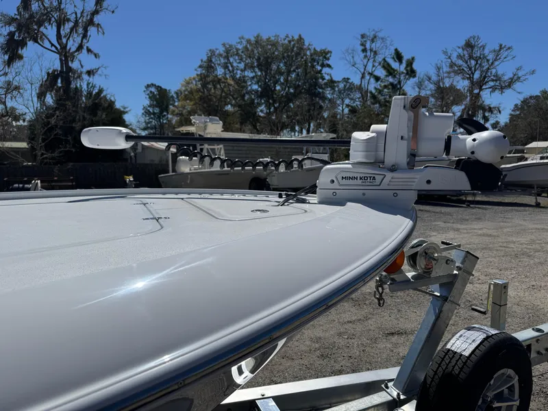 Slide: The Image of 2025 Contender 26 Bay boat on trailer, featuring Minn Kota trolling motor. - 12