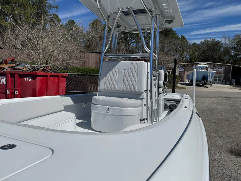 Slide: The Image of 2025 Contender 26 Bay boat with sleek design and comfortable seating in a sunny outdoor setting. - 14