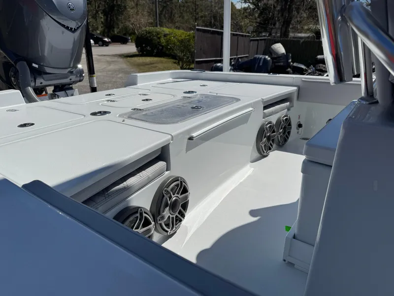 Slide: The Image of 2025 Contender 26 Bay boat interior with speakers and storage compartments. - 20