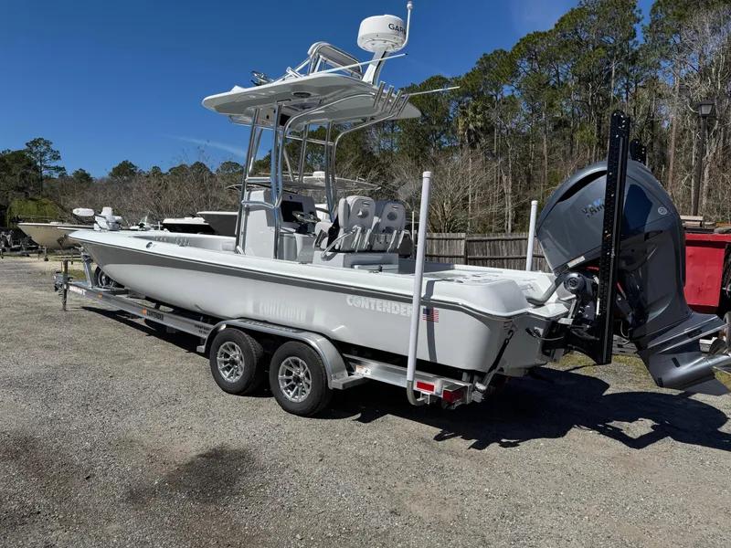 Slide: The Image of 2025 Contender 26 Bay boat on trailer, parked outdoors, with clear blue sky. - 4