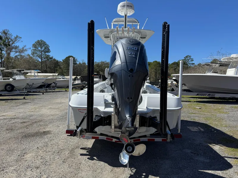 Slide: The Image of 2025 Contender 26 Bay boat with powerful engine, parked outdoors. - 5
