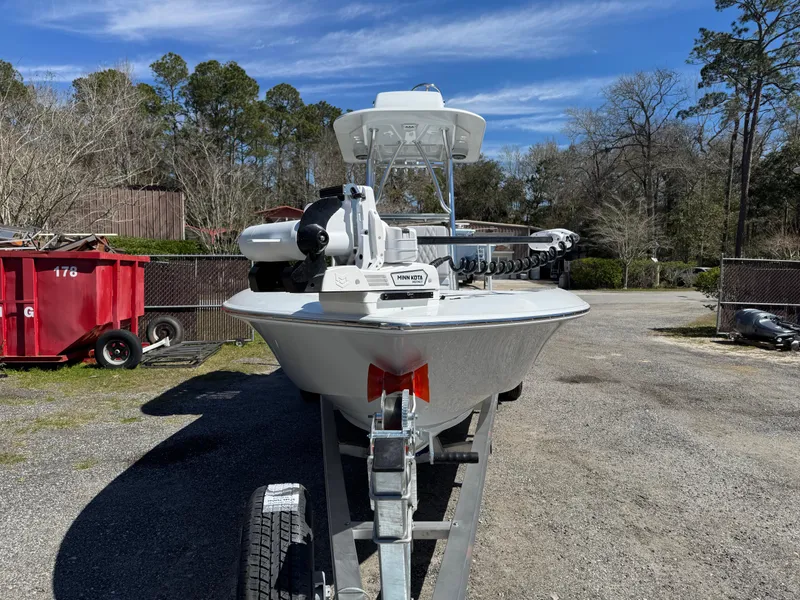 Slide: The Image of 2025 Contender 26 Bay boat on trailer, parked outdoors under clear sky. - 7
