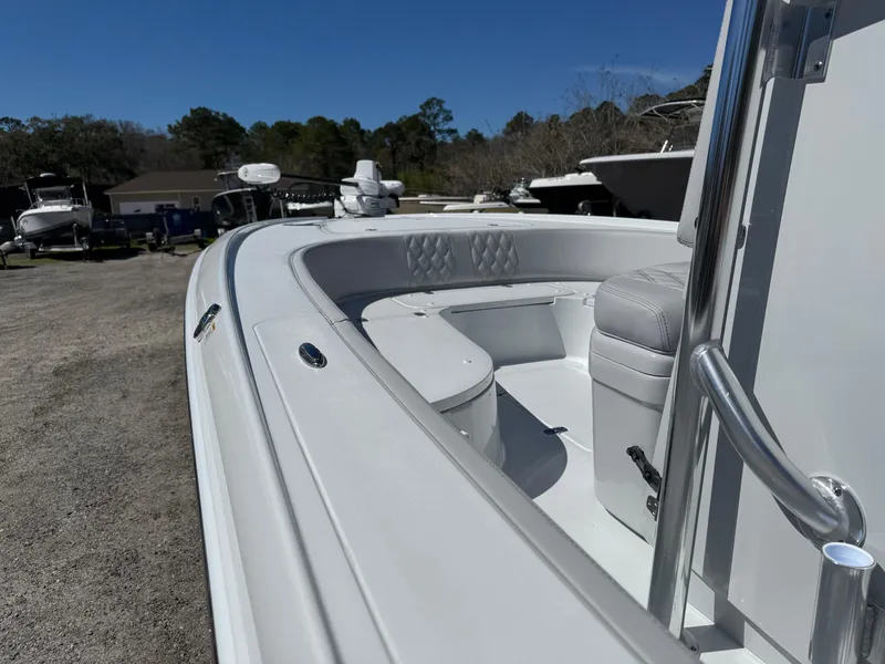 Slide: The Image of 2025 Contender 26 Bay boat interior with seating, parked outdoors. - 15