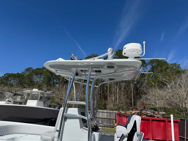 Slide: The Image of 2025 Contender 26 Bay boat with radar, clear sky background. - 25
