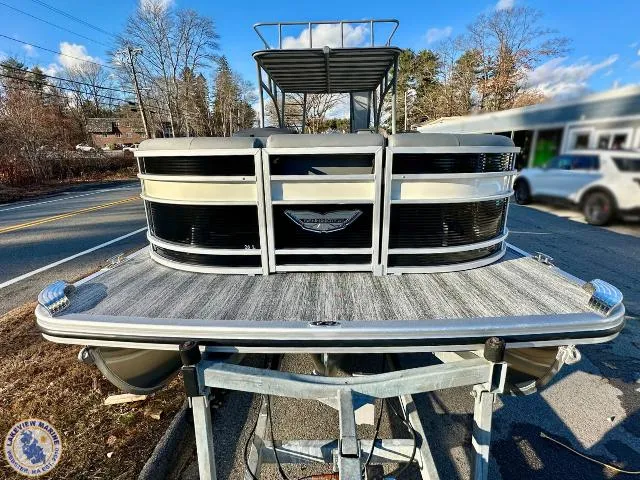 Slide: The Image of 2025 Bennington 26 LSRTD pontoon boat on trailer, parked roadside. - 20