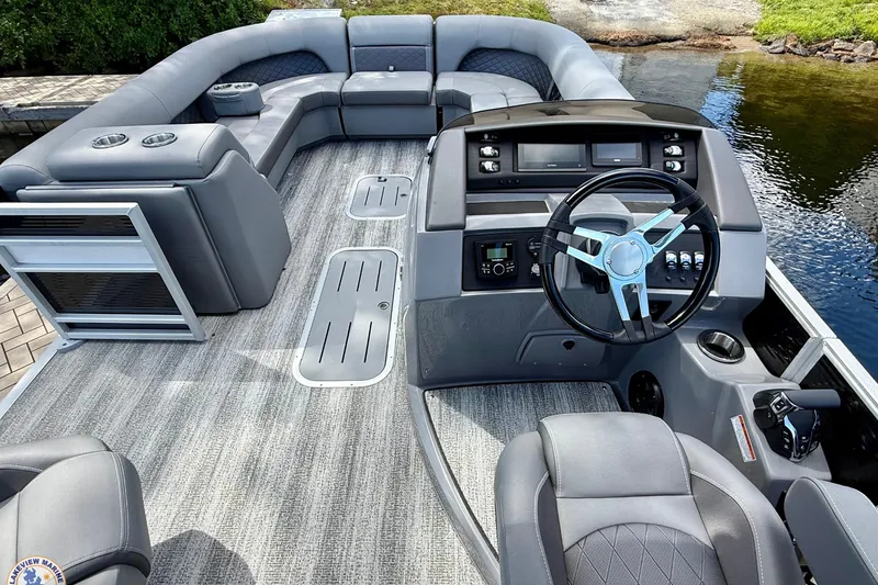 Slide: The Image of 2025 Bennington 26 LSRTD pontoon boat interior with modern helm and spacious seating. - 8