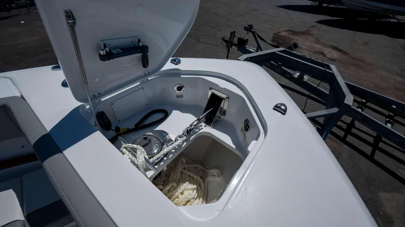Slide: The Image of Open anchor compartment of 2025 Everglades 455 CC boat, showcasing storage and equipment. - 13