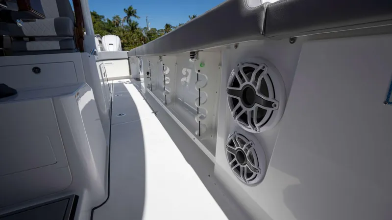 Slide: The Image of Everglades 455 CC 2025 boat interior with speakers and seating, showcasing modern design. - 18