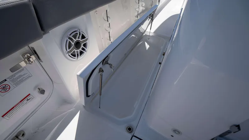 Slide: The Image of Interior view of 2025 Everglades 455 CC boat, featuring storage compartment and speaker. - 22