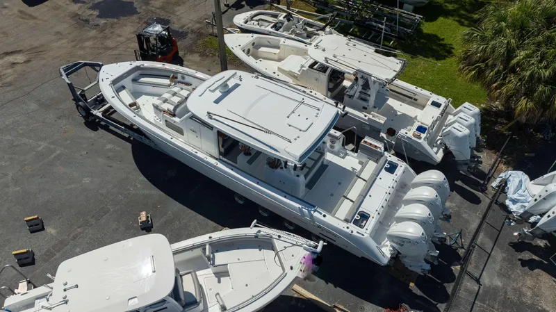 Slide: The Image of Aerial view of 2025 Everglades 455 CC boats in a marina setting. - 4