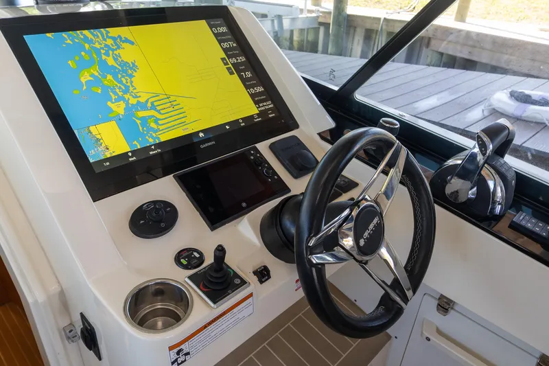 Slide: The Image of Control panel of a 2020 Scout 530LXF boat with navigation display and steering wheel. - 11
