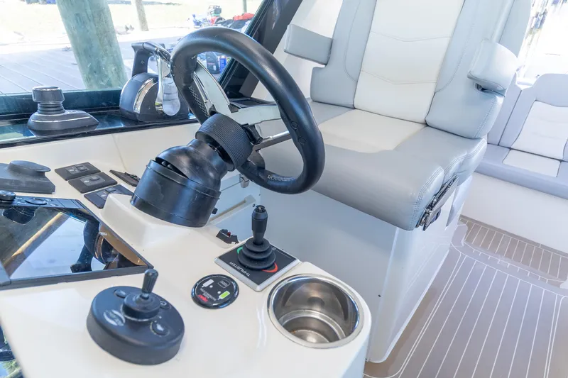 Slide: The Image of 2020 Scout 530LXF boat helm with steering wheel and controls. - 14