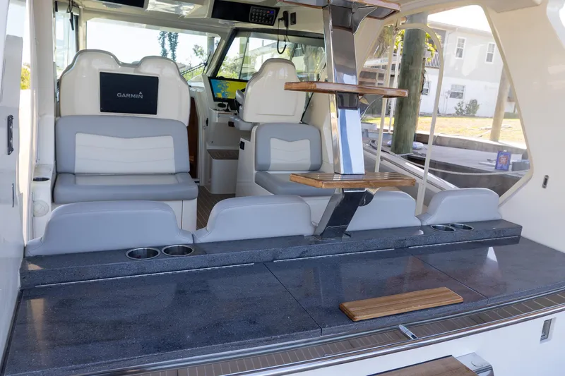 Slide: The Image of 2020 Scout 530LXF boat interior with seating, helm, and modern amenities. - 16