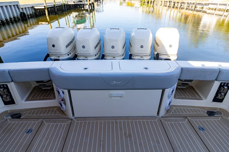 Slide: The Image of 2020 Scout 530LXF boat with five powerful outboard engines docked by the water. - 21