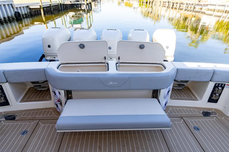 Slide: The Image of 2020 Scout 530LXF boat with open storage compartments and seating at the stern. - 23