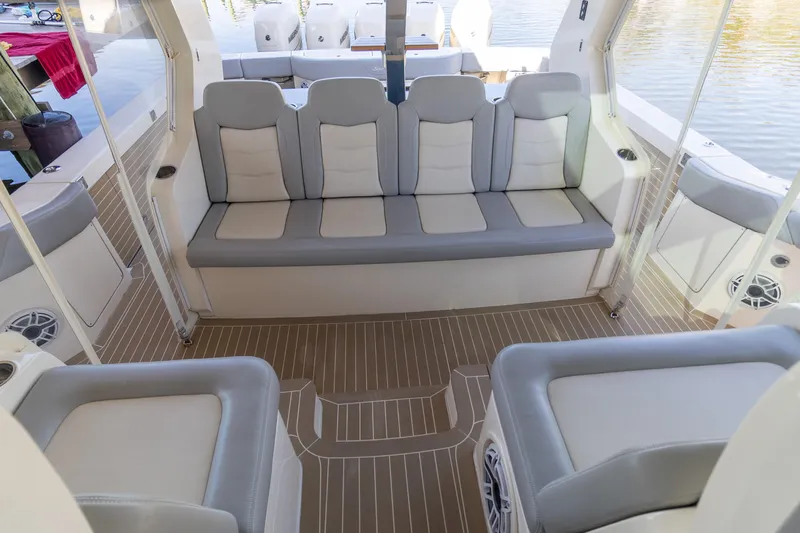 Slide: The Image of 2020 Scout 530LXF boat interior with gray seating and wood flooring. - 24