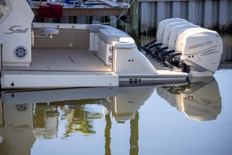 Slide: The Image of 2020 Scout 530LXF boat with multiple outboard engines docked on calm water. - 3