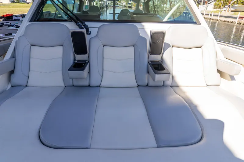 Slide: The Image of Luxurious seating on 2020 Scout 530LXF boat, featuring plush cushions and cup holders. - 30