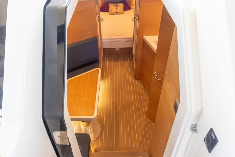 Slide: The Image of Interior view of 2020 Scout 530LXF boat cabin with seating and bed. - 32