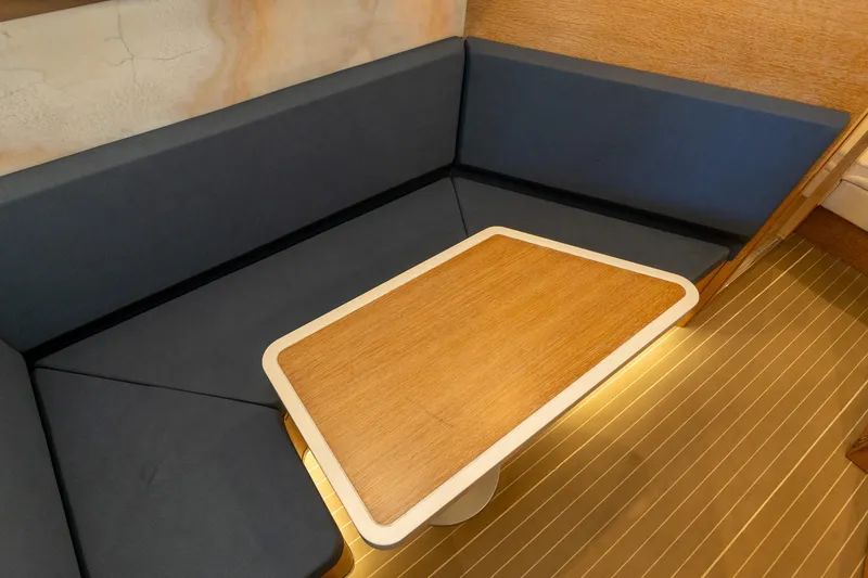 Slide: The Image of 2020 Scout 530LXF interior with wooden table and blue cushioned seating. - 33