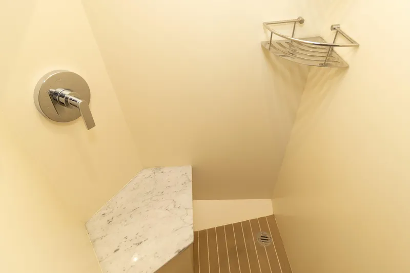 Slide: The Image of Shower area in 2020 Scout 530LXF boat with marble shelf and wooden floor. - 40