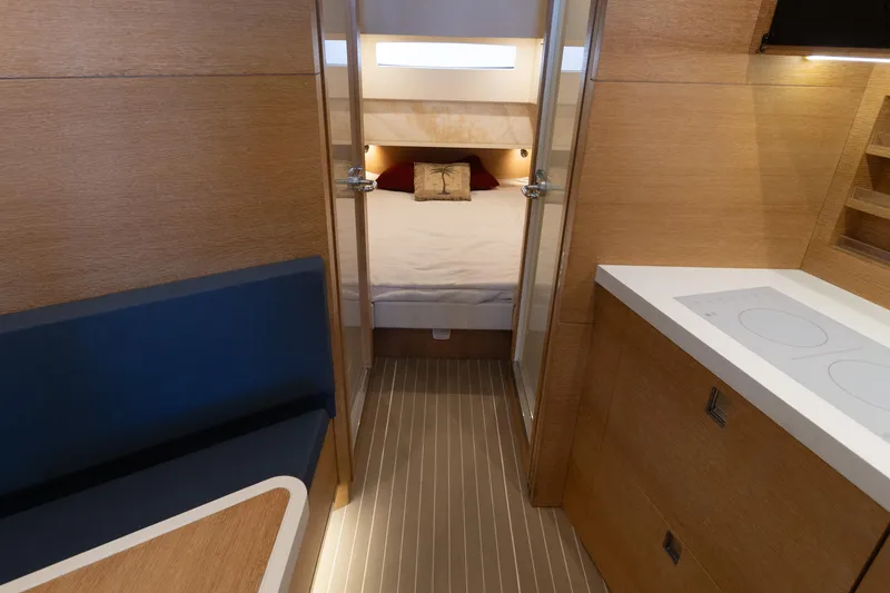 Slide: The Image of 2020 Scout 530LXF interior with modern wood finish, cozy bed, and compact kitchen area. - 43