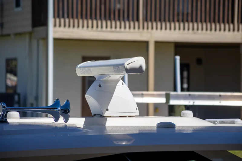 Slide: The Image of Radar equipment on 2020 Scout 530LXF boat, docked near a building. - 7