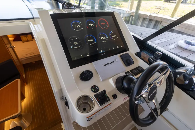 Slide: The Image of Control panel of 2020 Scout 530LXF boat with digital display and steering wheel. - 9