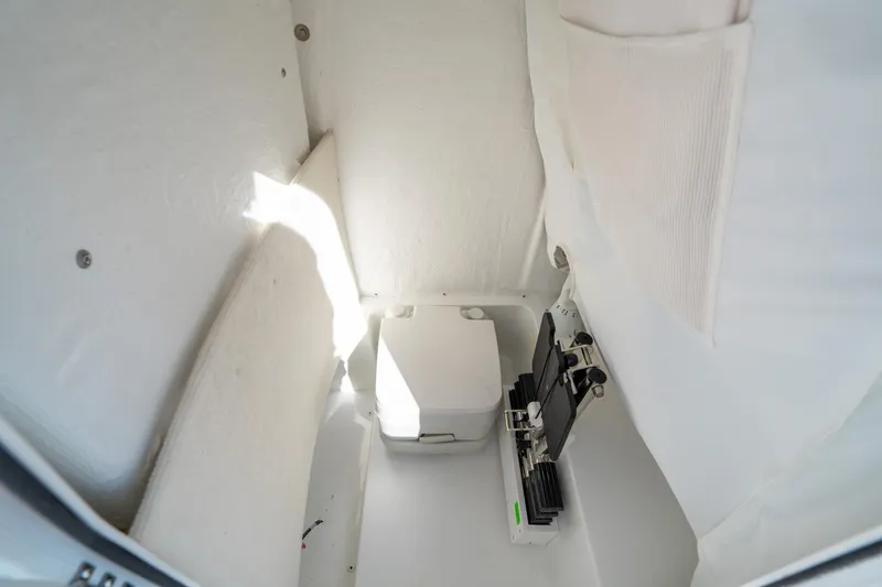 Slide: The Image of Interior of 2025 Sea Hunt Ultra 235 SE boat, featuring compact storage space. - 19