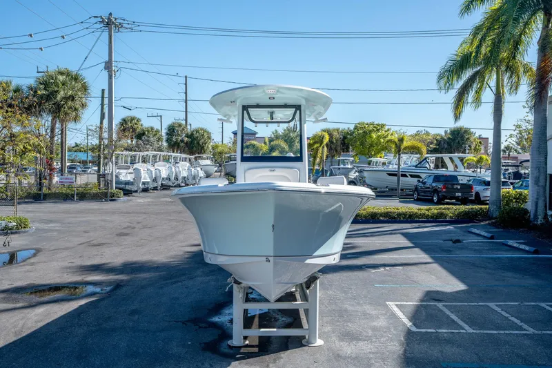 Slide: The Image of 2025 Sea Hunt Ultra 235 SE boat displayed outdoors on a sunny day. - 7