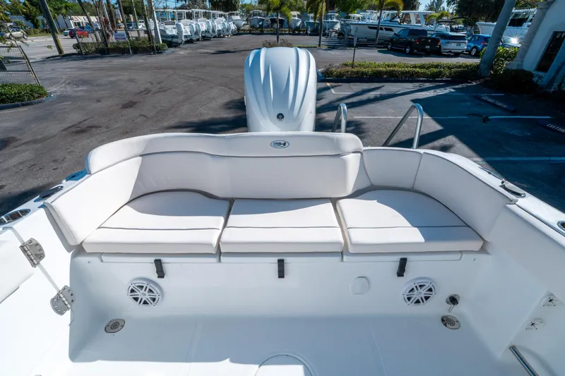 Slide: The Image of 2025 Sea Hunt Ultra 235 SE boat with white cushioned seating and speakers. - 10