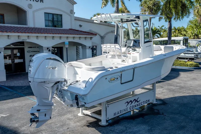 Slide: The Image of 2025 Sea Hunt Ultra 235 SE boat displayed at Marine Connection dealership. - 2