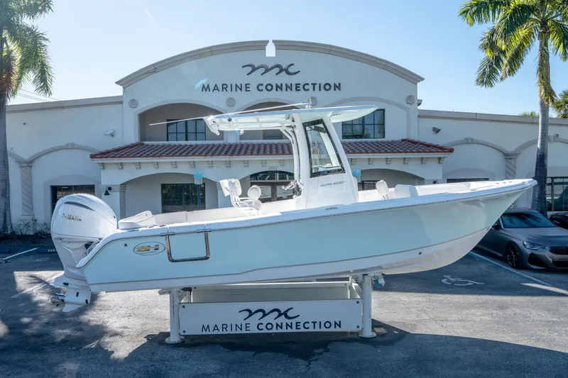 Slide: The Image of 2025 Sea Hunt Ultra 235 SE boat displayed at Marine Connection dealership. - 1