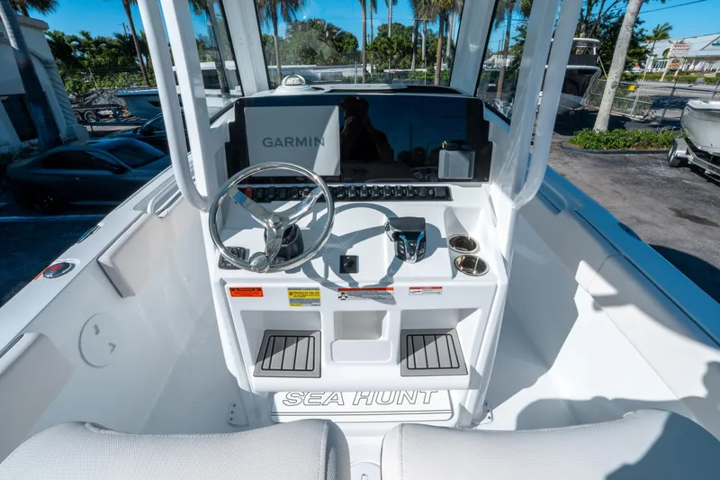 Slide: The Image of 2025 Sea Hunt Ultra 235 SE boat dashboard with Garmin navigation system and steering wheel. - 14