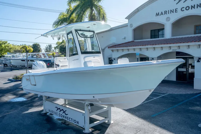Slide: The Image of 2025 Sea Hunt Ultra 235 SE boat displayed at Marine Connection dealership. - 8