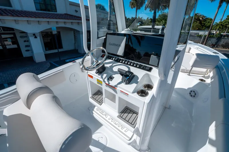 Slide: The Image of 2025 Sea Hunt Ultra 235 SE boat helm with Garmin display and steering wheel. - 15
