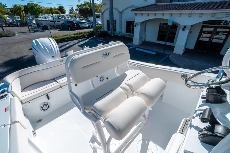 Slide: The Image of 2025 Sea Hunt Ultra 235 SE boat interior with plush seating and steering wheel. - 17