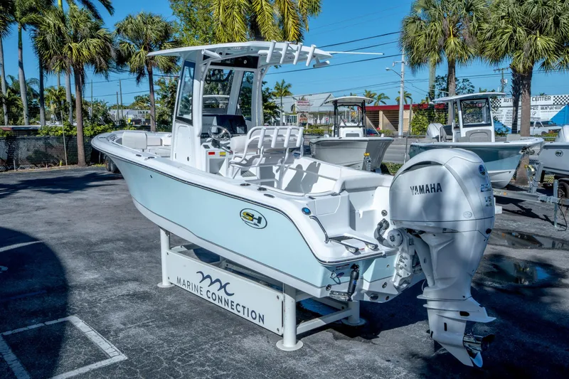 Slide: The Image of 2025 Sea Hunt Ultra 235 SE boat with Yamaha engine, displayed outdoors. - 4