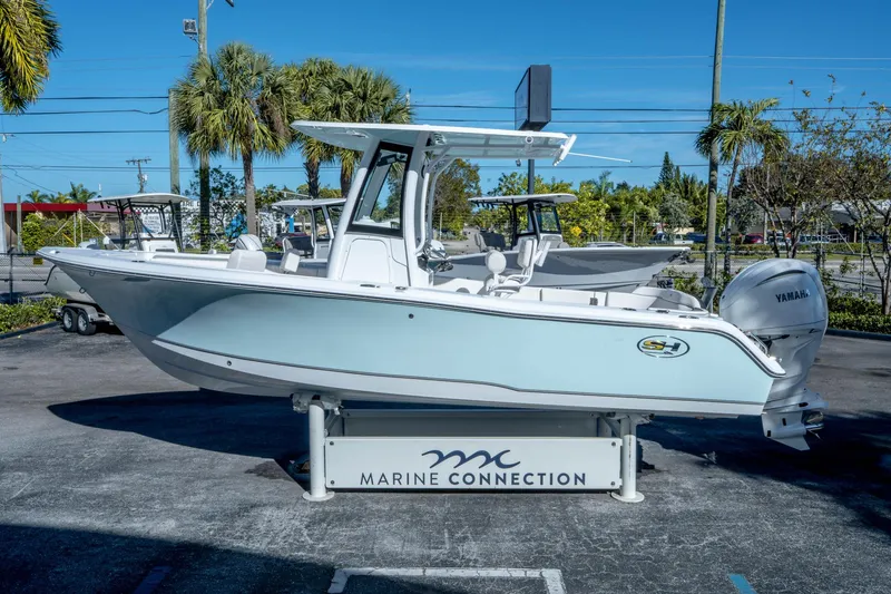 Slide: The Image of 2025 Sea Hunt Ultra 235 SE boat displayed at Marine Connection dealership. - 5