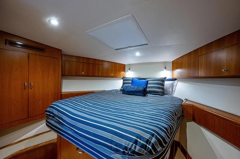 Slide: The Image of Luxurious cabin interior of 2012 Cabo 44 HTX yacht with striped bedding. - 12