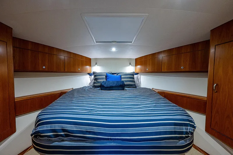 Slide: The Image of Luxurious cabin interior of 2012 Cabo 44 HTX yacht with striped bedding. - 13